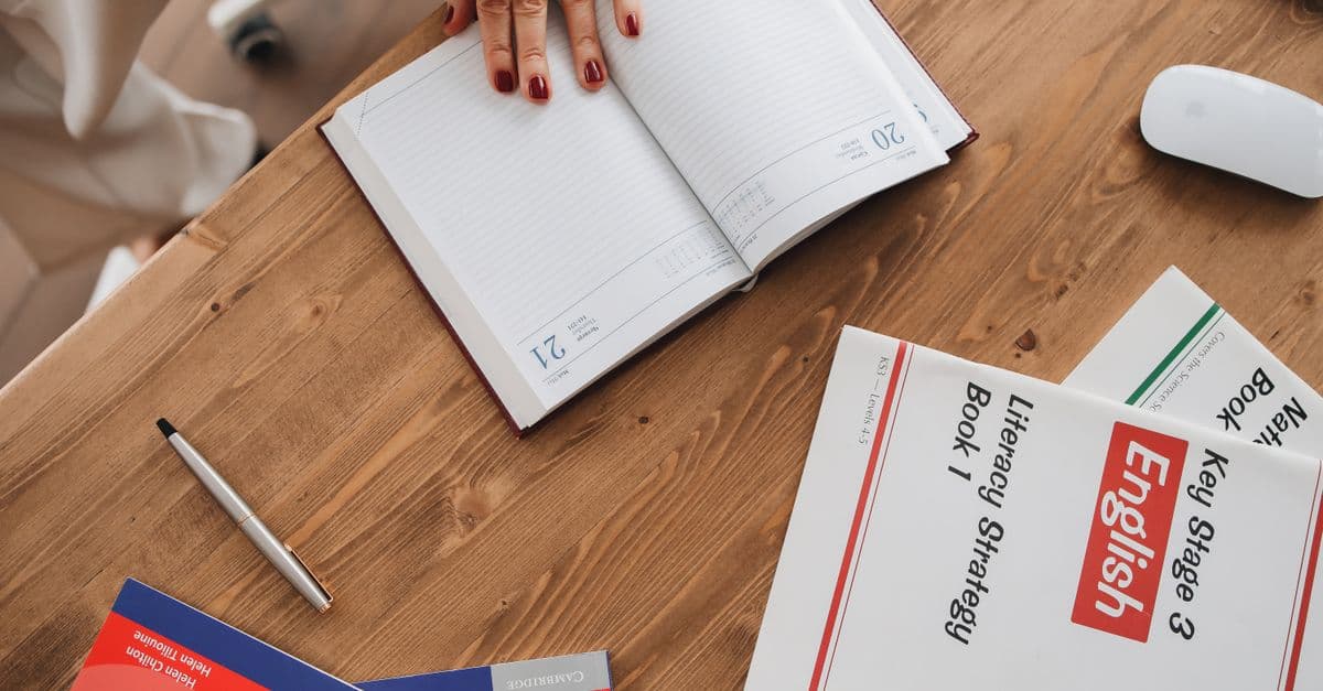 Estudante de inglês estudando com caderno — Present Continuous com Wrecking Ball